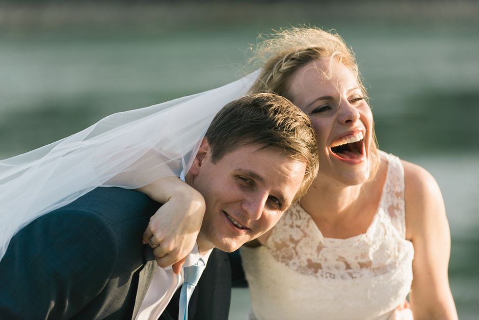 Candid wedding photography showing bride and groom laughing