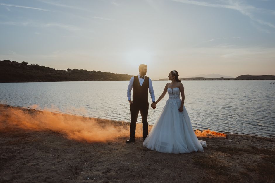Wedding couple embracing at sunset